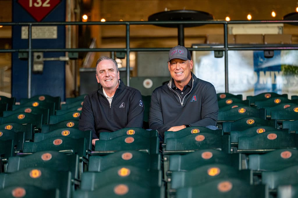 Two Arizona Diamondbacks executives photographed in the empty seating bowl at Chase Field