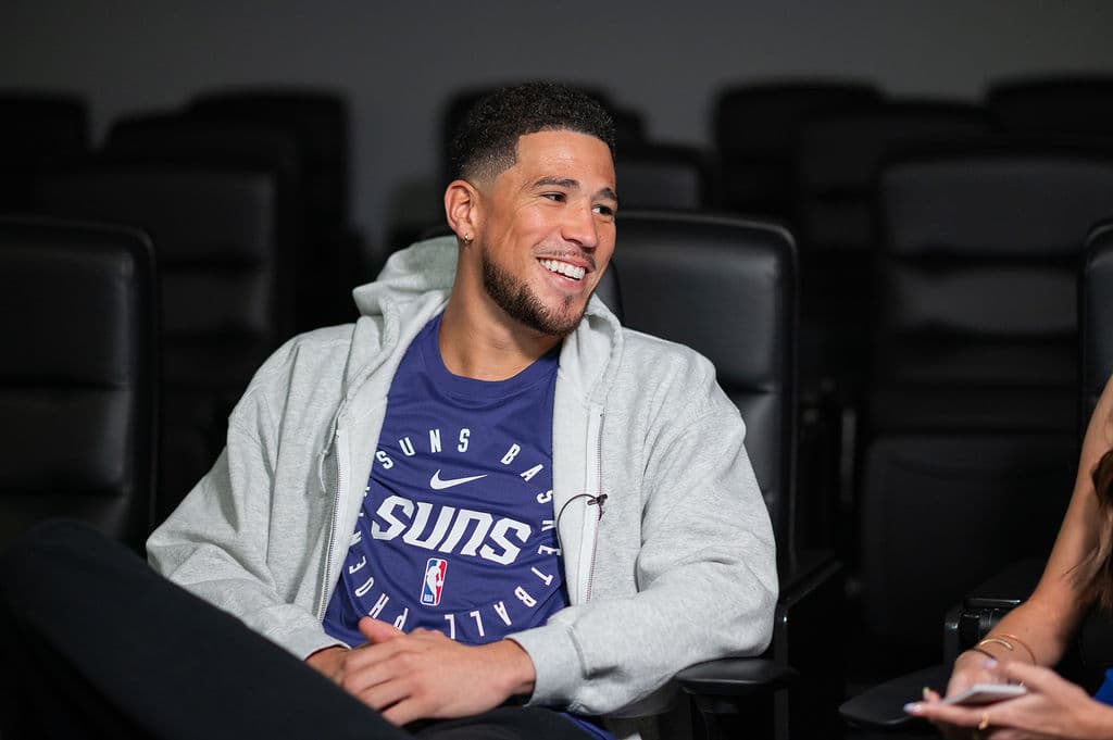 Phoenix Suns guard Devin Booker laughing during a relaxed media day interview