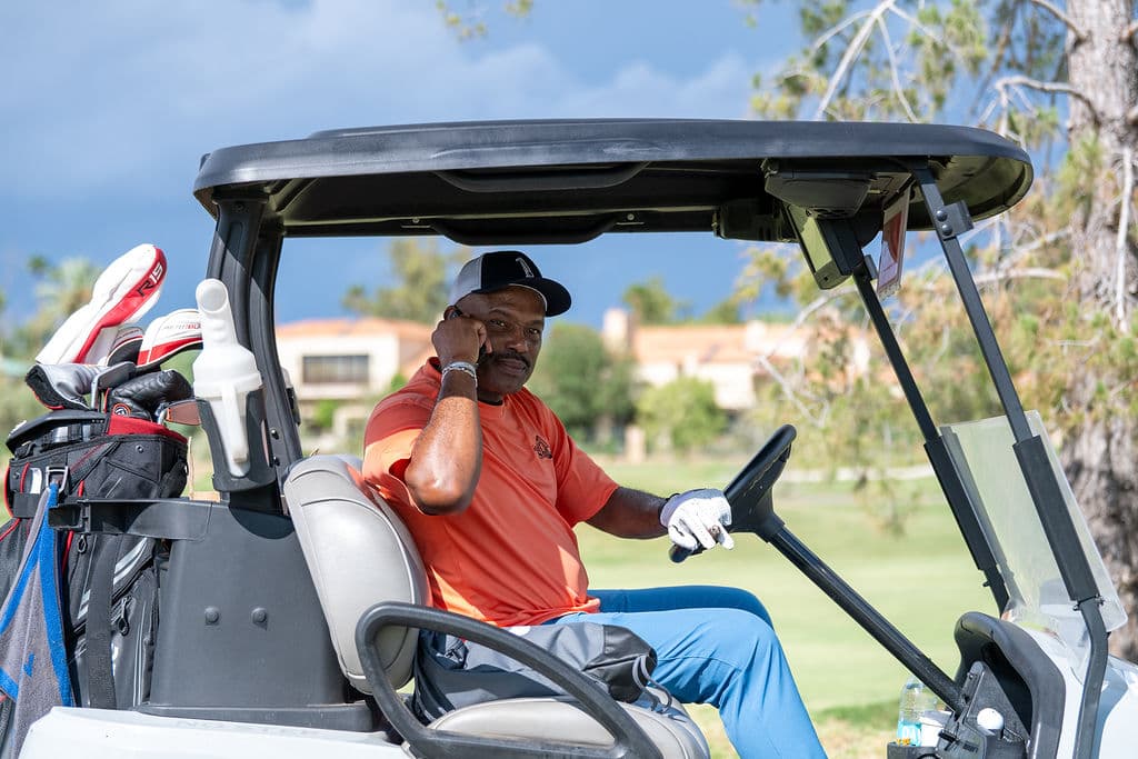 Golfer in a cart on the course during the Jerry Colangelo Basketball Hall of Fame Golf Classic in Arizona