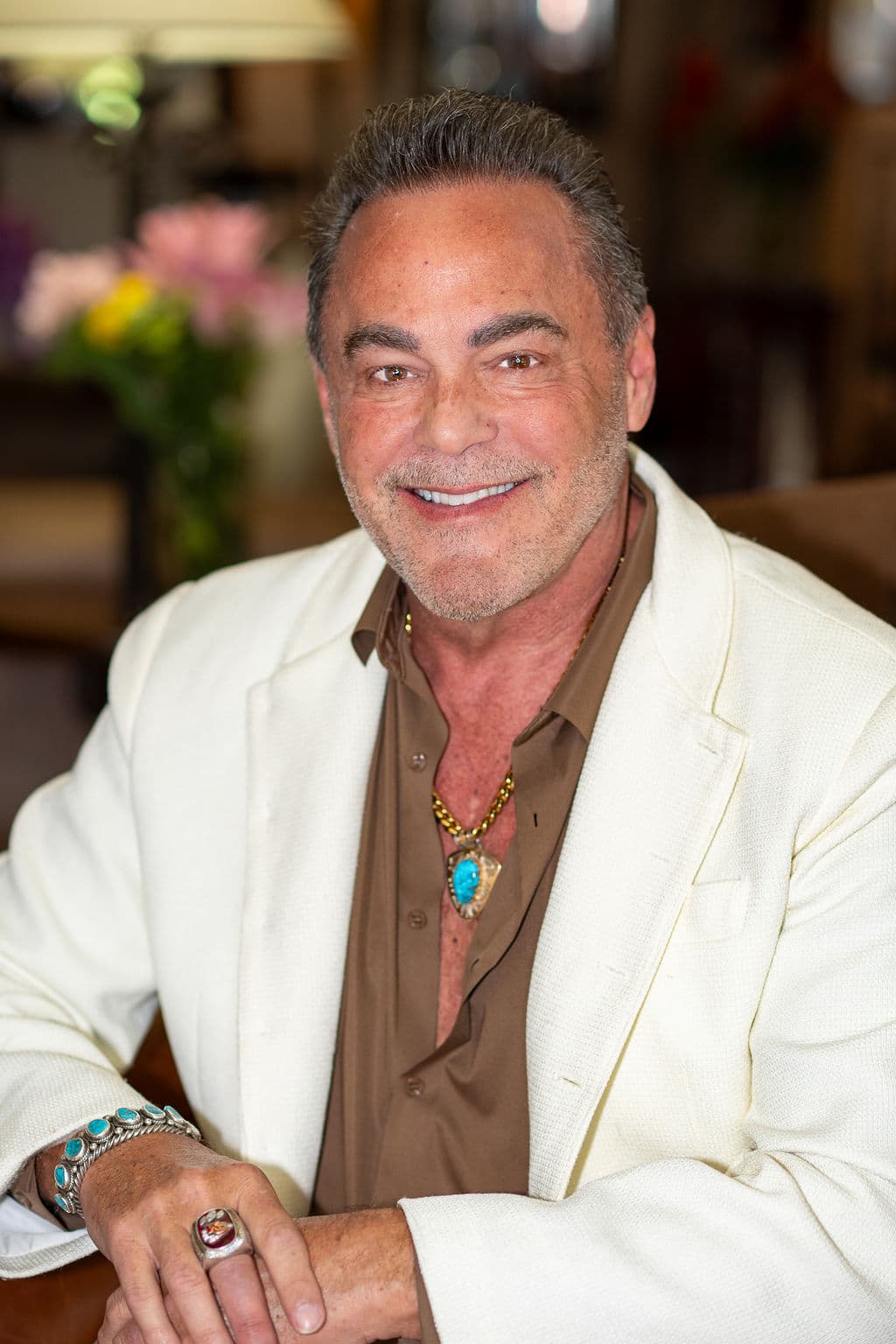 Relaxed executive portrait of former NFL kicker Nick Lowery in a cream jacket, shot on location
