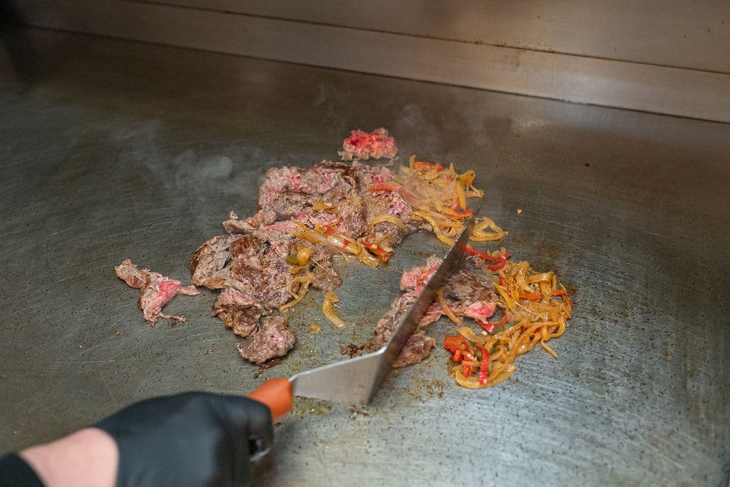 Chef finishing steak and peppers on the flat top during a private dining experience at Hotel Valley Ho