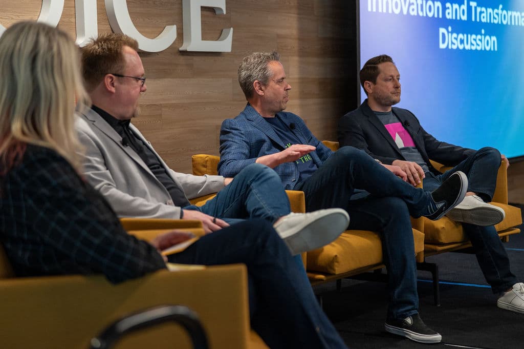 Four panelists seated on stage during an innovation and transformation discussion at a Choice Hotels conference